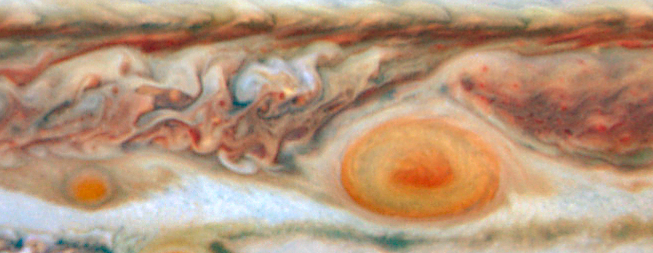 A close-up view of Jupiter’s southern hemisphere. The Great Red Spot is shown on the right side. To the direct left of it is a much smaller red spot.