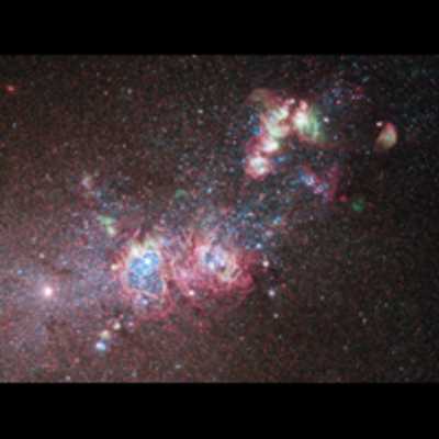 Several gas clouds stretch diagonally across the image, with two large, roughly circular cavities in the gas.