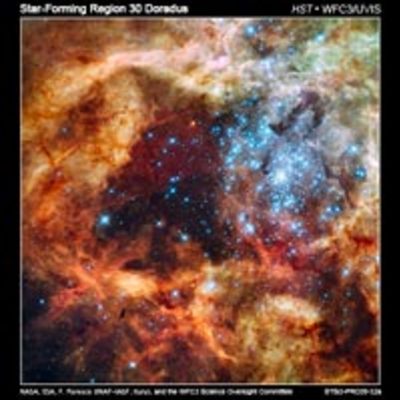 Framed image of a dense cluster of bright blue-white stars surrounded by fluffy orange and brown material.