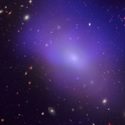 A sheer purple blob takes up the majority of the image, angled from top left to bottom right. The background is littered with small galaxies, some closer and others in the far distance.