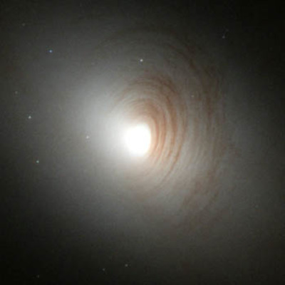 Tightly Wound Arms of Dust Encircle Nucleus of Galaxy NGC 2787