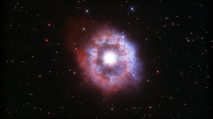 Bright star surrounded by shell of gas and dust