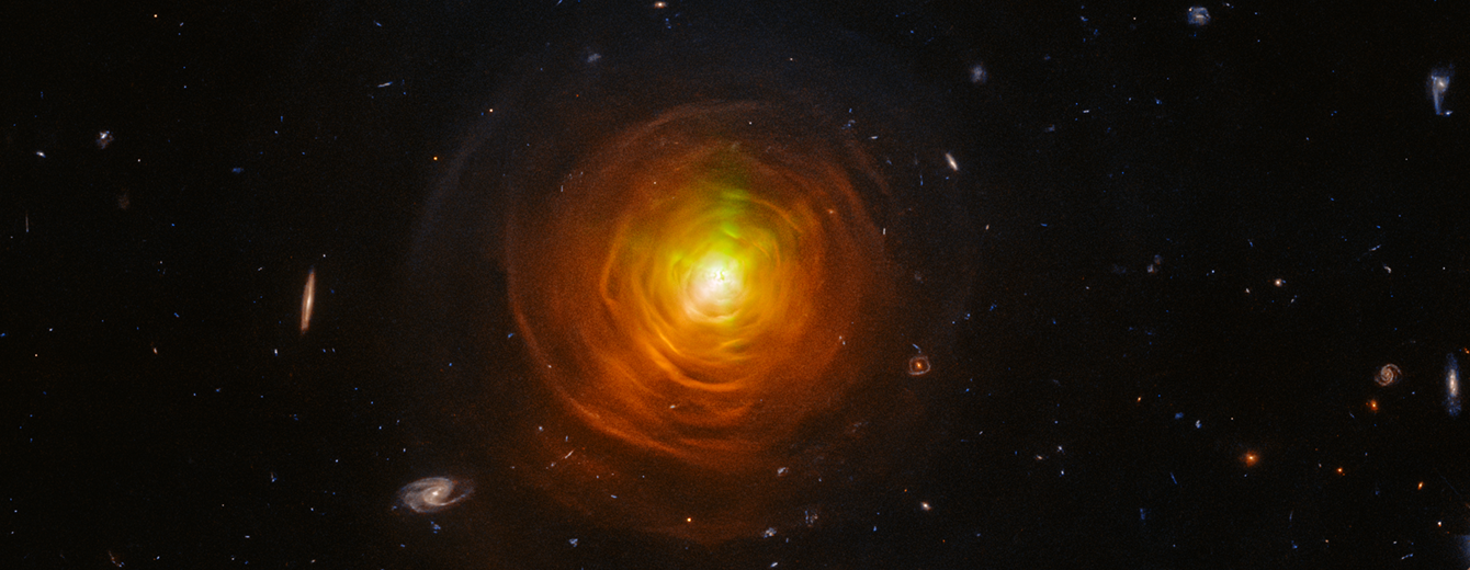 Red-orange arcs surround the carbon star CW Leonis. Brilliant searchlight beams from the star’s surface poke through.