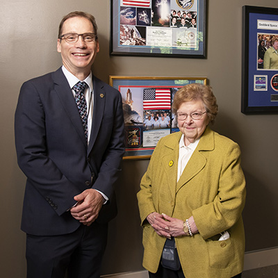 Photo of Ken Sembach (left) and Barbara Mikulski (right) in front of three framed mementos from Mikulski's donated collection