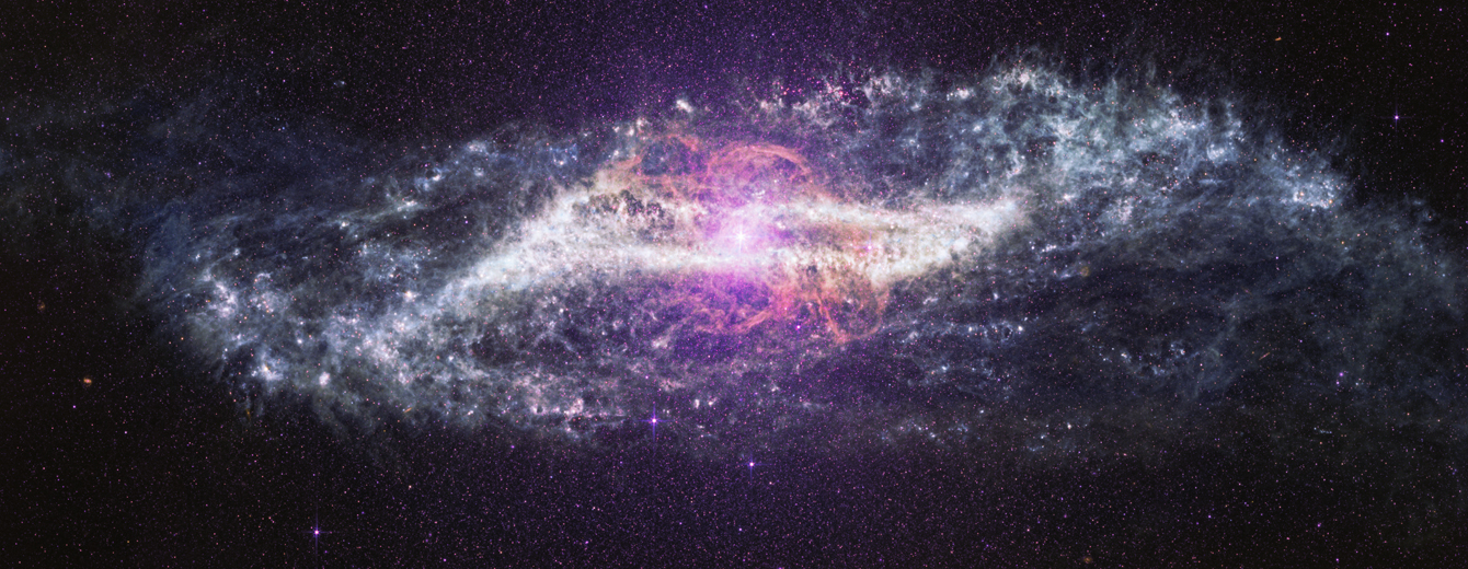 A horizontal image of the galaxy Centaurus A stretches across a black background filled with thousands of tiny purple, pink, and white points of light. The galaxy is brightest at its center, where a brilliant white and pale pink glow radiates outward. Eight diffraction spikes extend from the central glow. Delicate loops and wispy ribbons of pink and lavender arc above and below the center of the image in the shape of an ‘S’. A band of gray and white dust in the shape of a parallelogram cuts across the middle of the galaxy. Mottled patches and bright knots are scattered throughout the dusty band. The galaxy’s outer edges fade into soft, cloud-like plumes with feathery textures that stretch toward the left and right sides of the image. Against the surrounding darkness, a few bright foreground stars shine with Webb’s distinctive diffraction spikes, while countless fainter stars create a speckled backdrop.